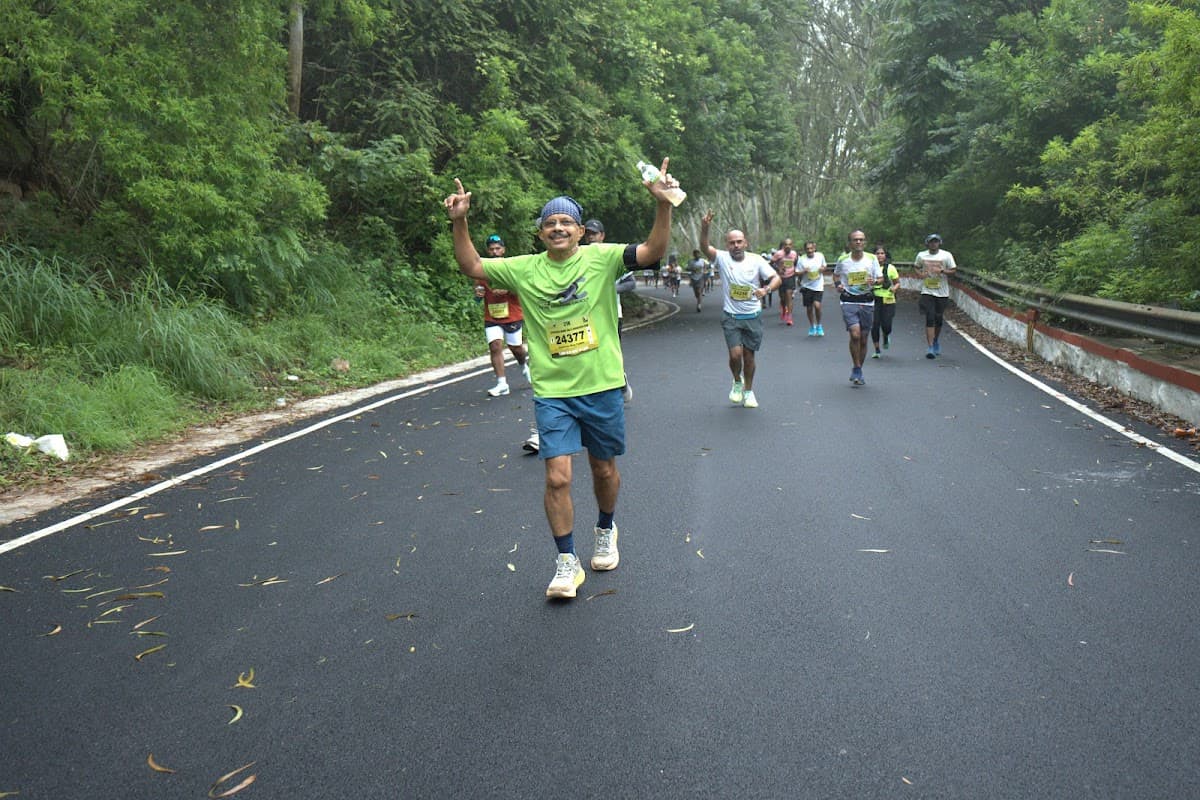Runner celebrating on the hill road