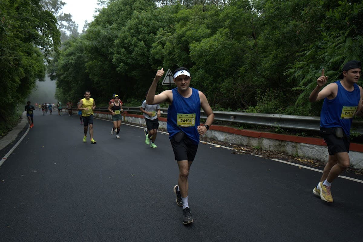 Runners pushing through fog on the hill