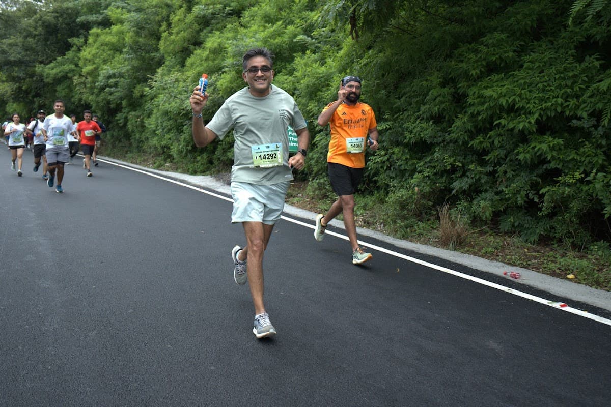 Runners on green hillside road