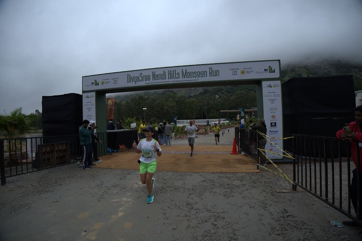 Runner crossing the finish line arch