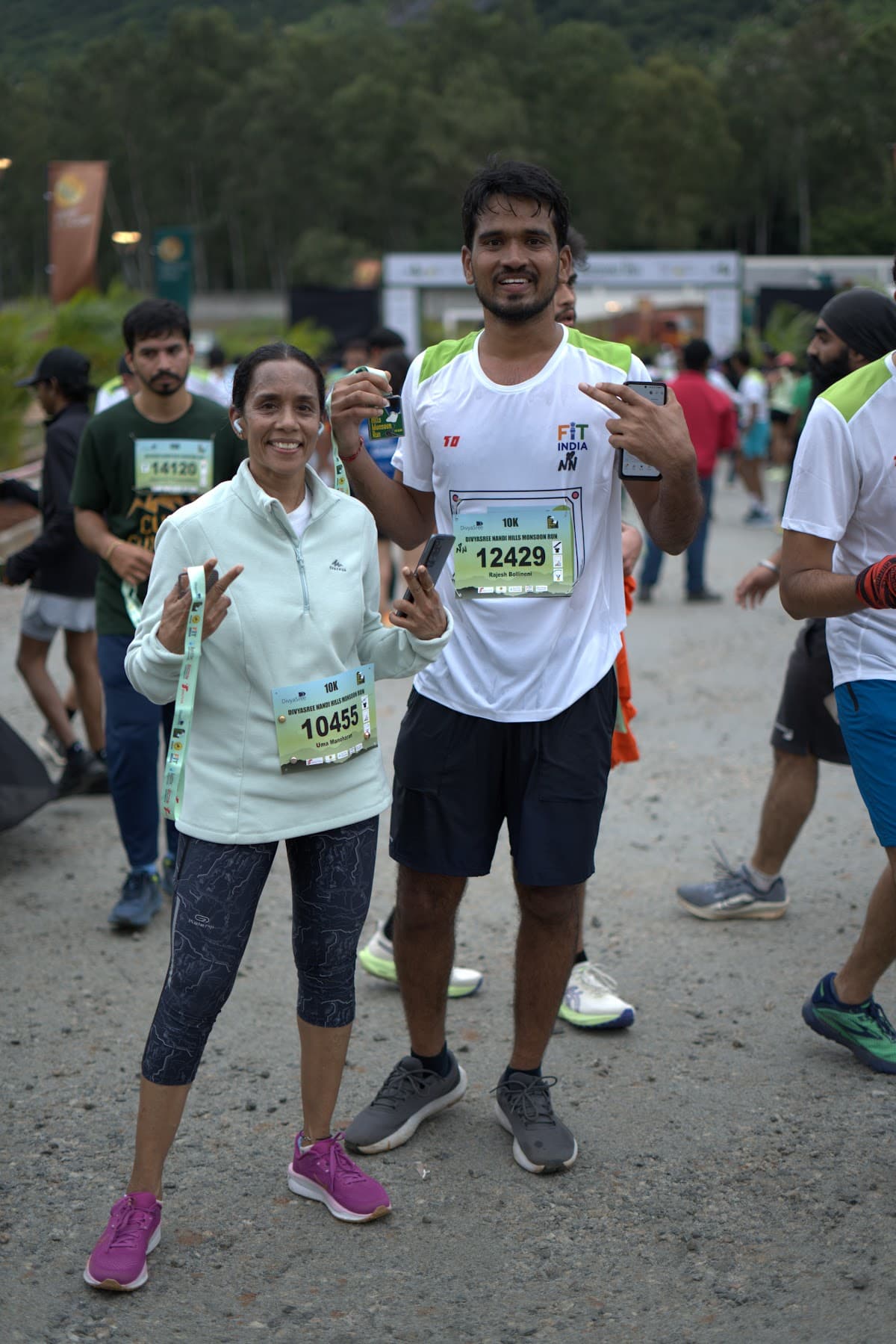 Two finishers celebrating with medals