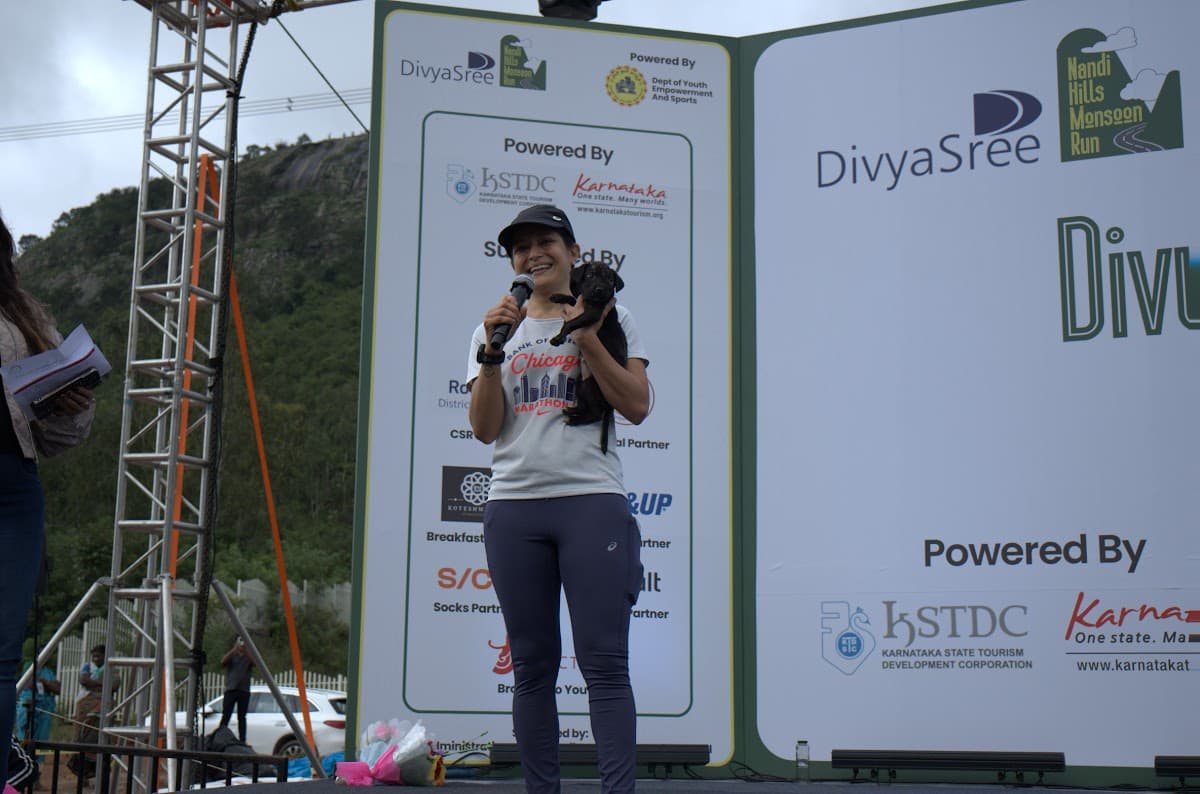 Speaker on stage with a puppy